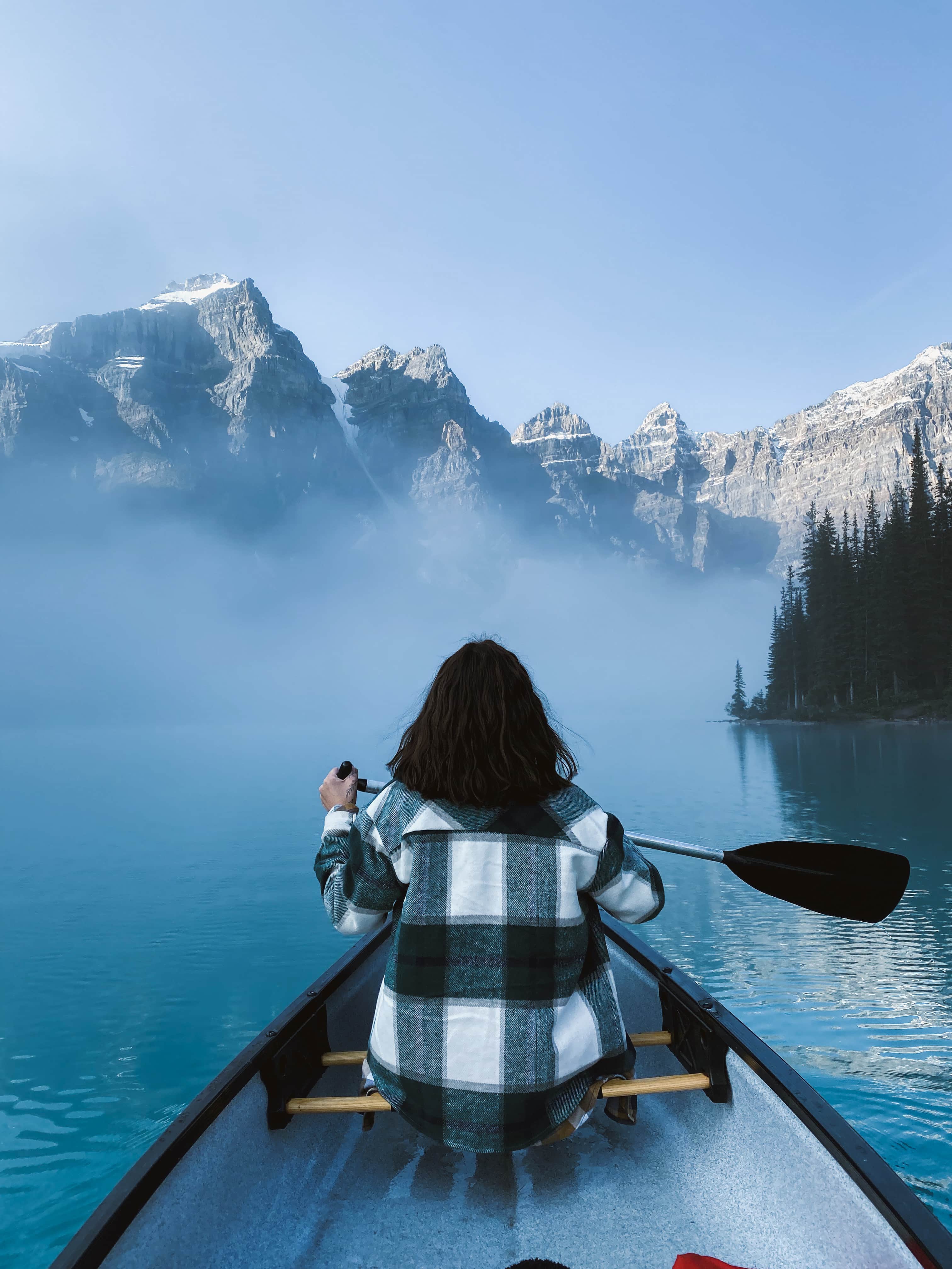 a girl canoeing on moraine lake in banff national park