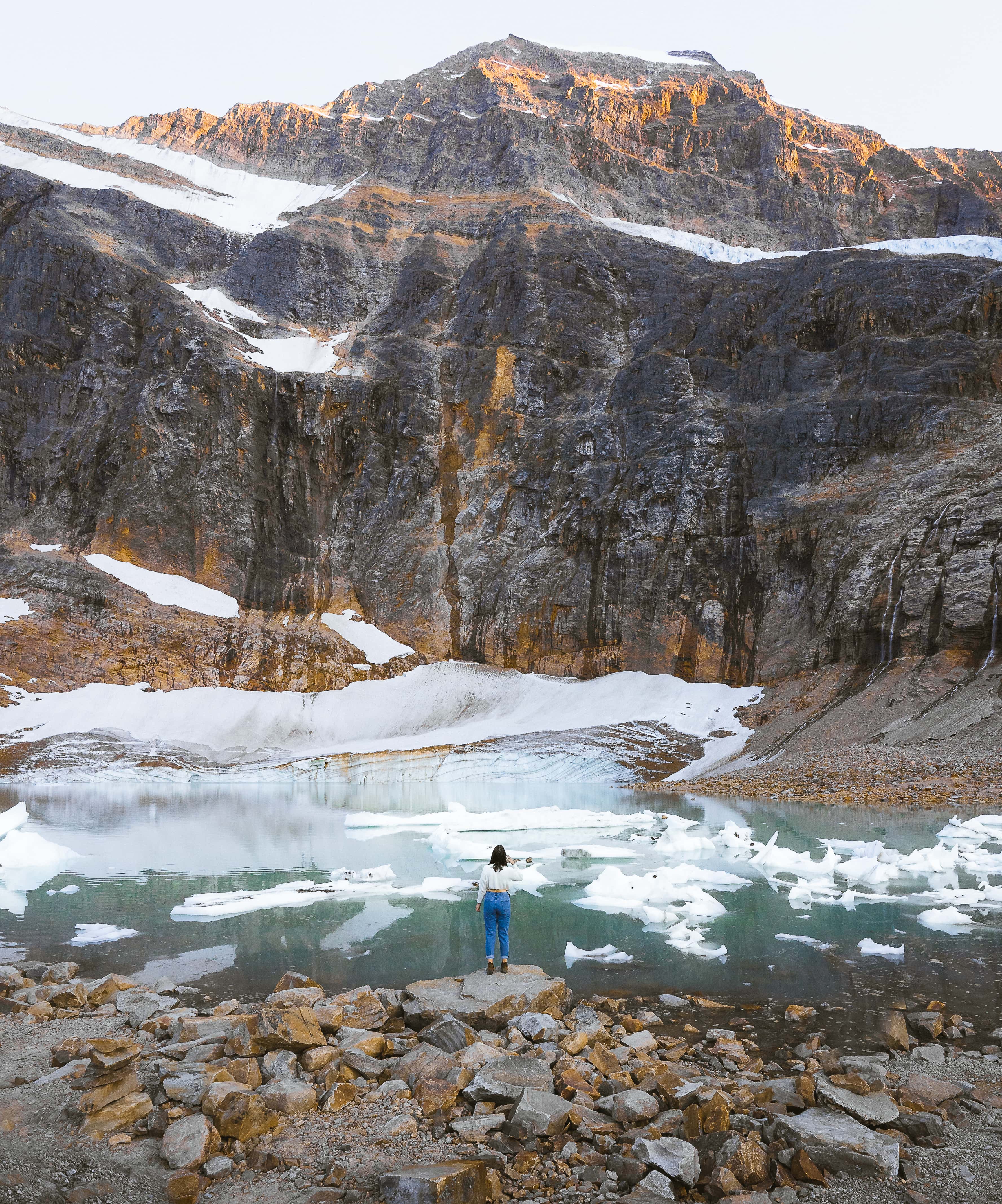 a girl standing at the base of mount edith cavell on path of the glacier trail in Jasper National Park,  best stops on the icefields parkway canada, drive the icefields parkway, icefields parkway stops
