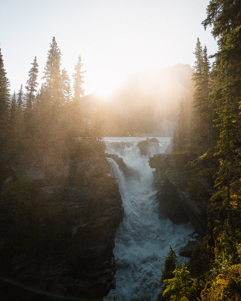 a photo of athabasca falls at sunset in the canadian rockies icefields parkway stops