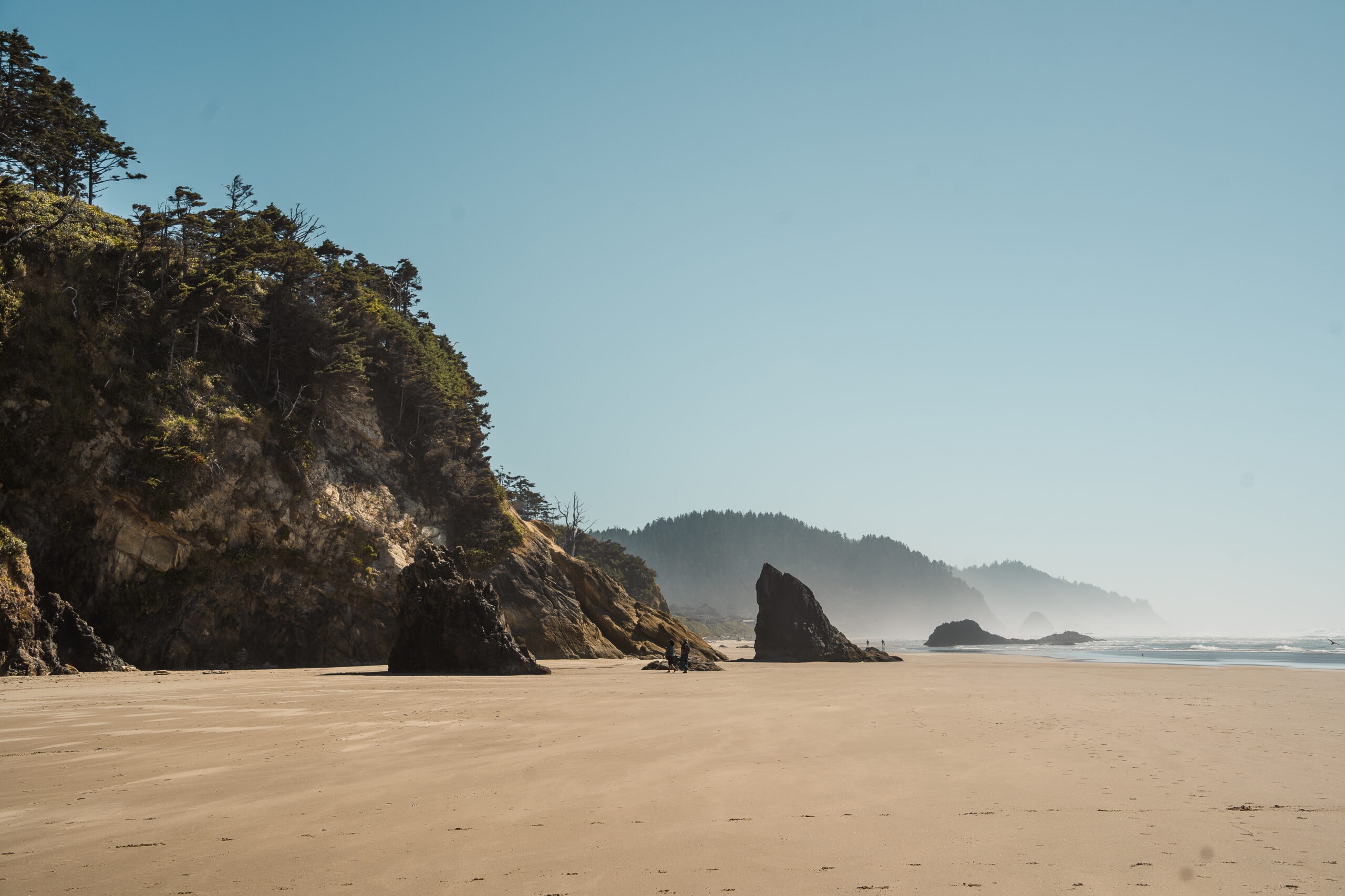 a view on the beach at Hug Point on the oregon coast road trip! Add this to your itinerary for when you road trip oregon