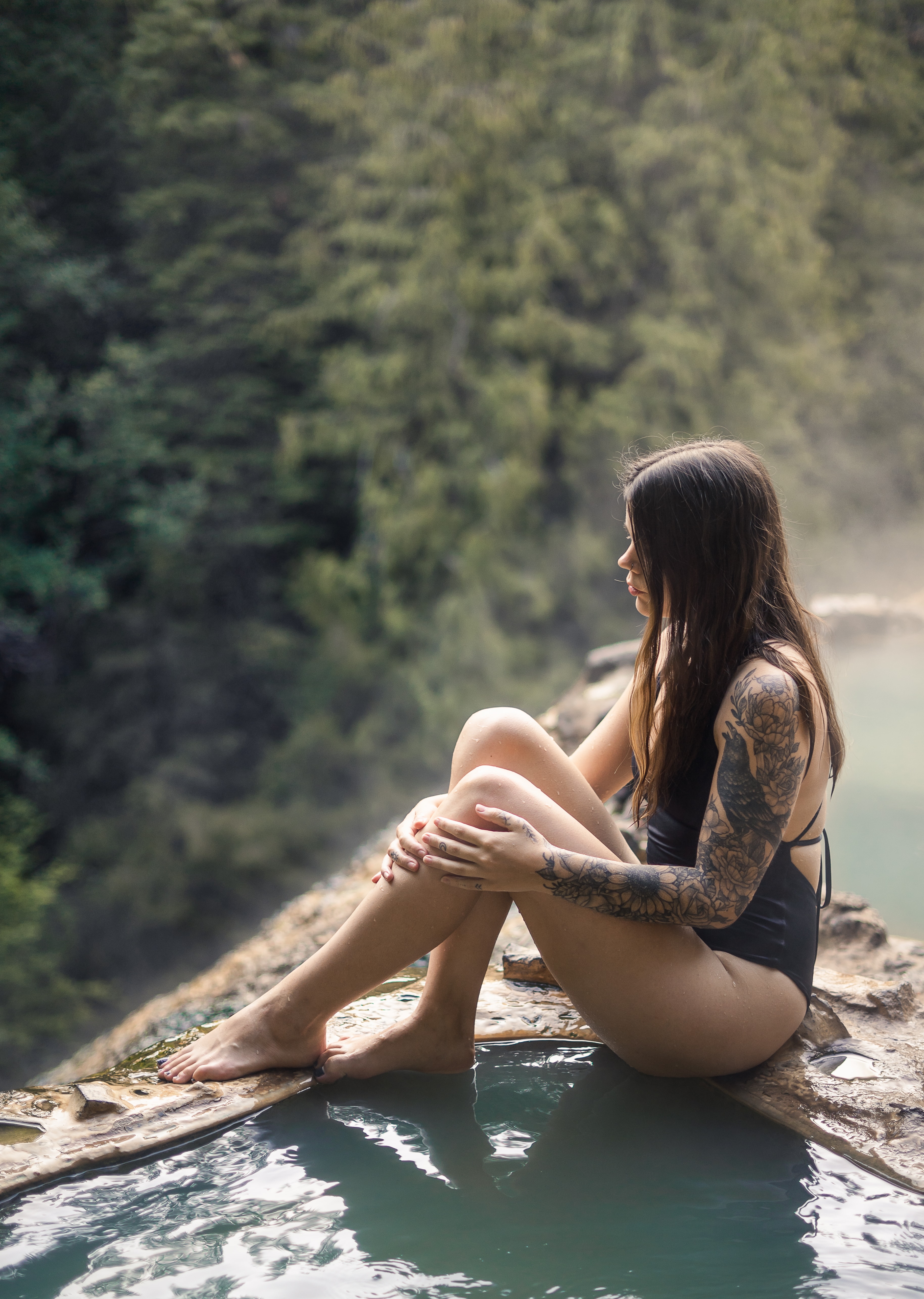 sitting by the hot springs in Umpqua National Forest. Umpqua Hot Springs are a must for your 10 day Oregon road trip itinerary